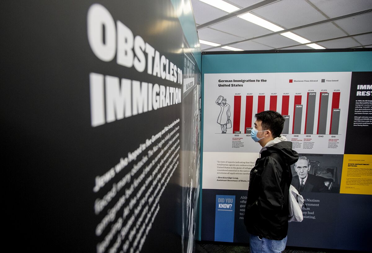 Tom Qu, 20, a junior at UC Irvine looks at a traveling exhibition called "Americans and the Holocaust."