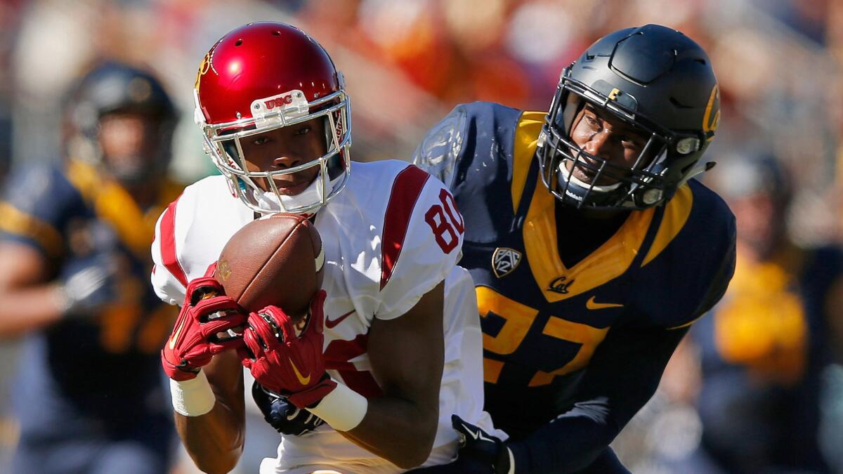 USC receiver Deontay Burnett makes a reception against California defensive back Damariay Drew in the first half Saturday.