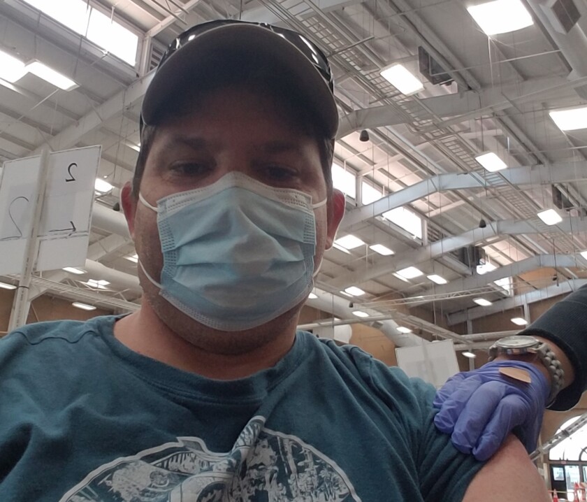 Dan McLellan receives his COVID-19 vaccine after volunteering in Del Mar