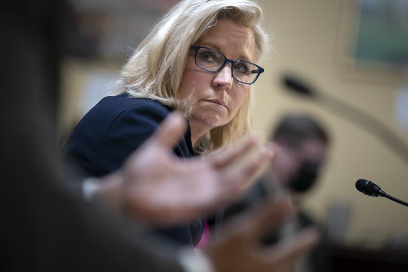 Vice Chair Liz Cheney, R-Wyo., of the House panel investigating the Jan. 6 U.S. Capitol insurrection, listens to Chairman Bennie Thompson, D-Miss., left, as he testifies before the House Rules Committee seeking contempt of Congress charges against former President Donald Trump's White House chief of staff Mark Meadows for not complying with a subpoena, at the Capitol in Washington, Tuesday, Dec. 14, 2021. A House vote to hold him in contempt would refer the charges to the Justice Department, which will decide whether to prosecute the former Republican congressman. (AP Photo/J. Scott Applewhite)
