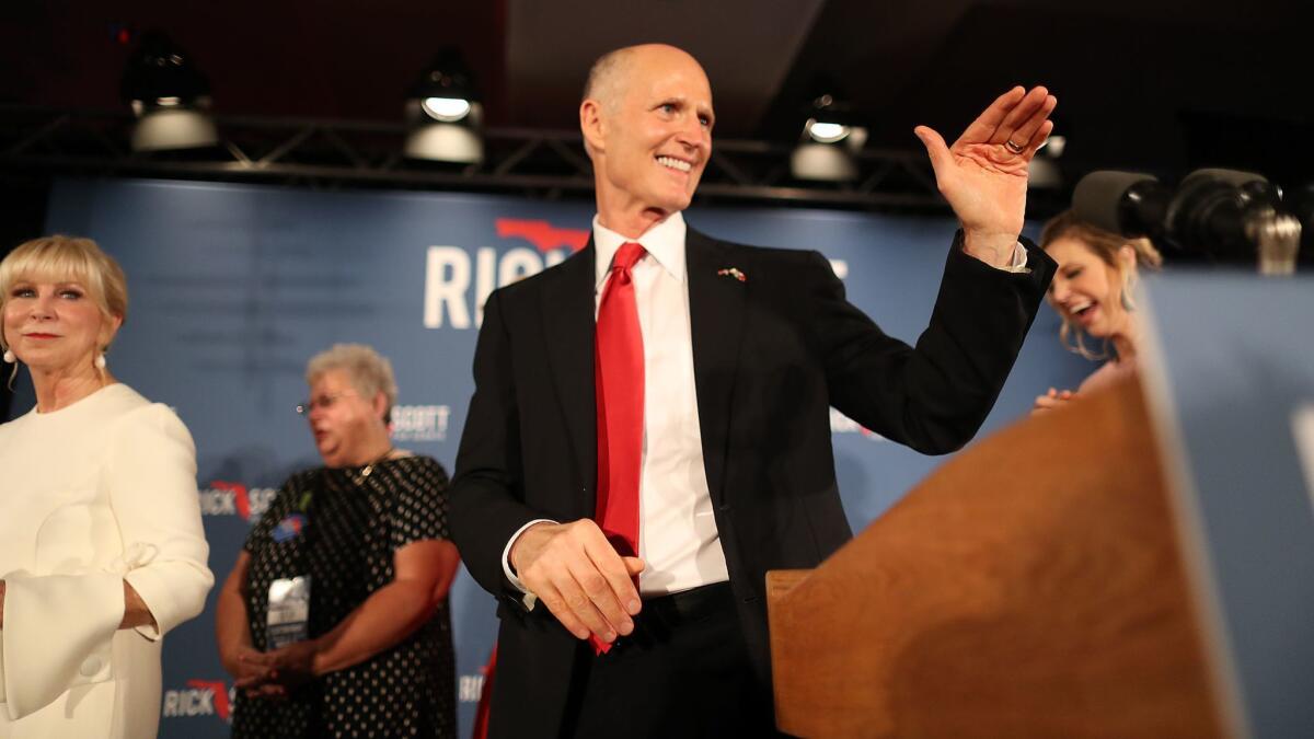 Florida Gov. Rick Scott and his wife, Ann Scott, take the stage during his election night party Nov. 6 in Naples, Fla.