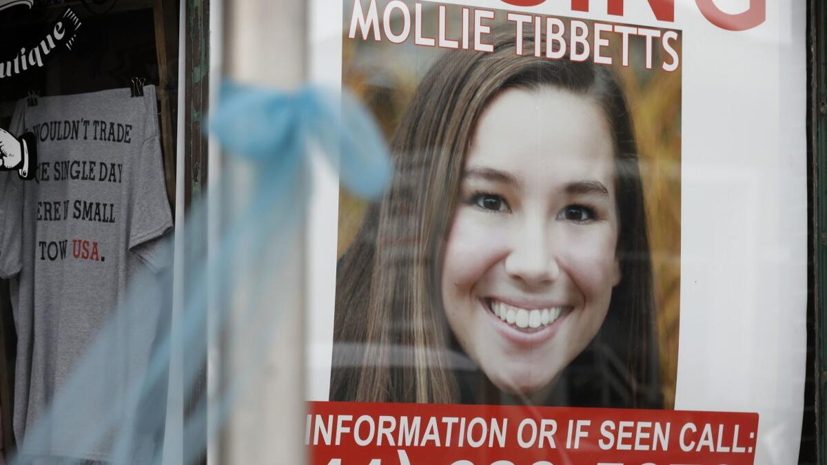 A poster of Mollie Tibbetts hangs in the window of a business in Brooklyn, Iowa.