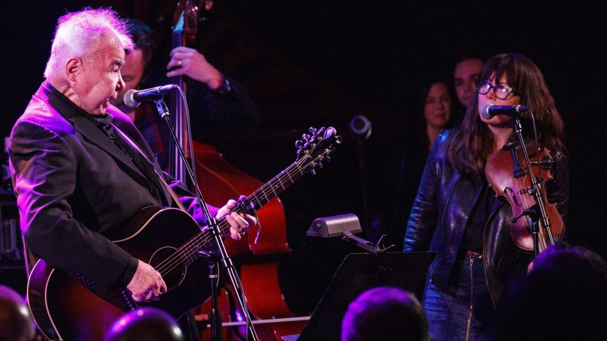 John Prine and Sara Watkins sing together during Saturday's tribute to Prine at The Troubadour in West Hollywood.