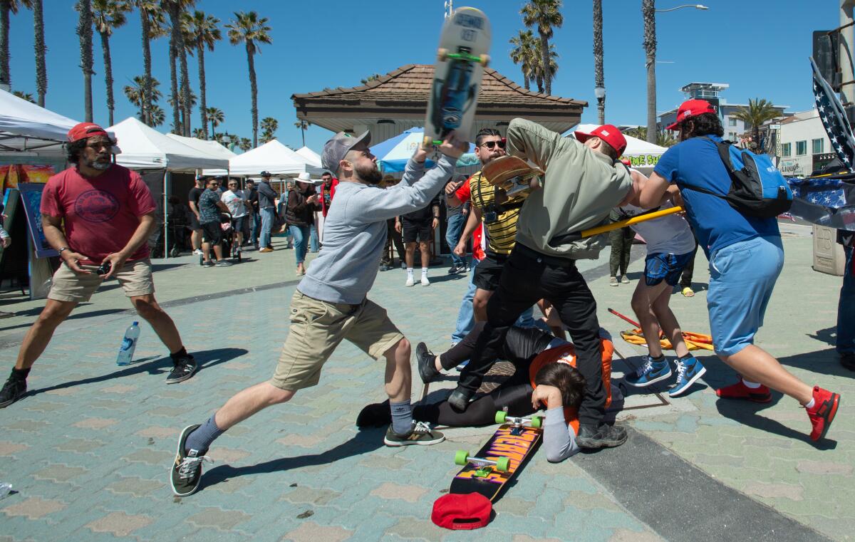 Skateboarders clash with demonstrators gathered in support of Trump at Huntington Beach Pier.