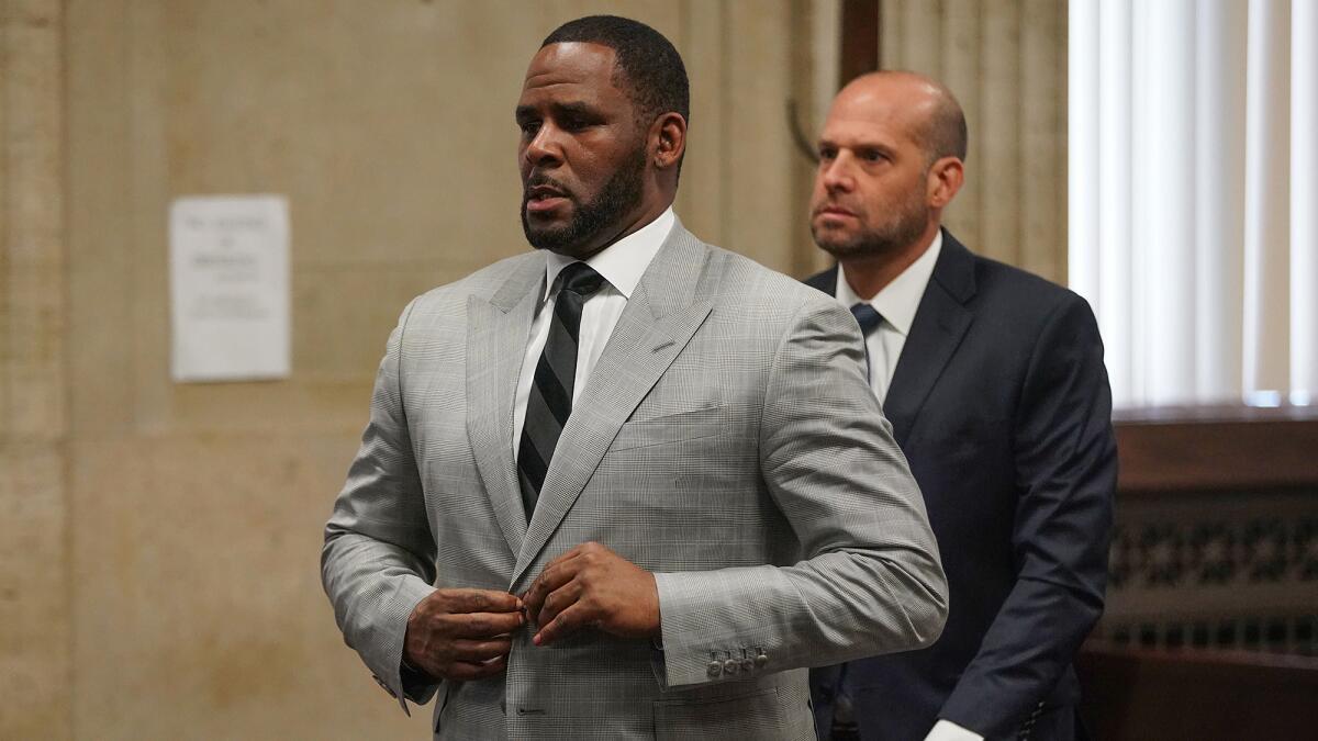 R. Kelly, left, wants out of the U.S. Metropolitan Correctional Center in Chicago, citing concerns that COVID-19 is spreading among inmates.