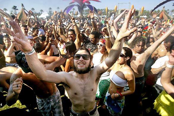 The crowd at the Coachella Valley Music and Arts Festival gets sprayed with water to offset temperatures that hovered in the century mark. The massive outdoor rock festival drew more than 125 bands, including musicians Prince, Roger Waters and Jack Johnson.