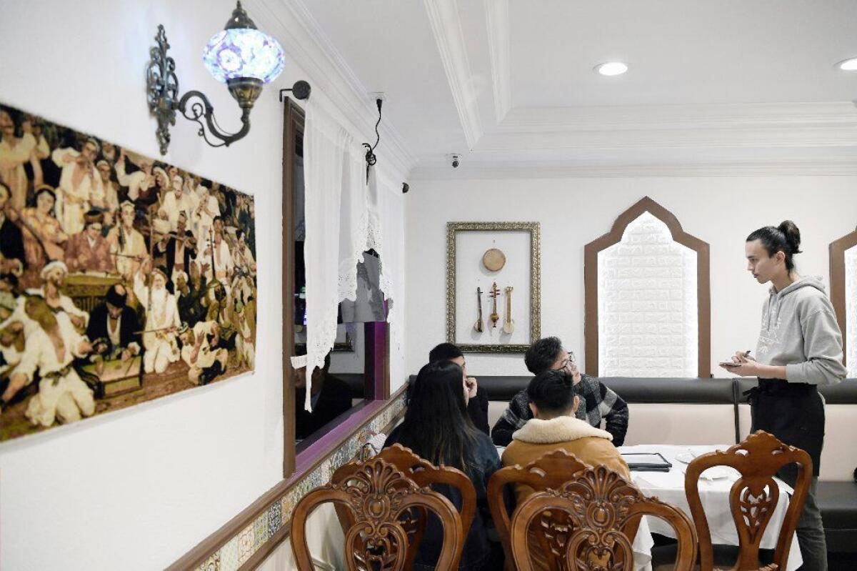 Dolan's decor includes a print of artist Ghazi Ahmet’s famous “Uyghur Muqam.”