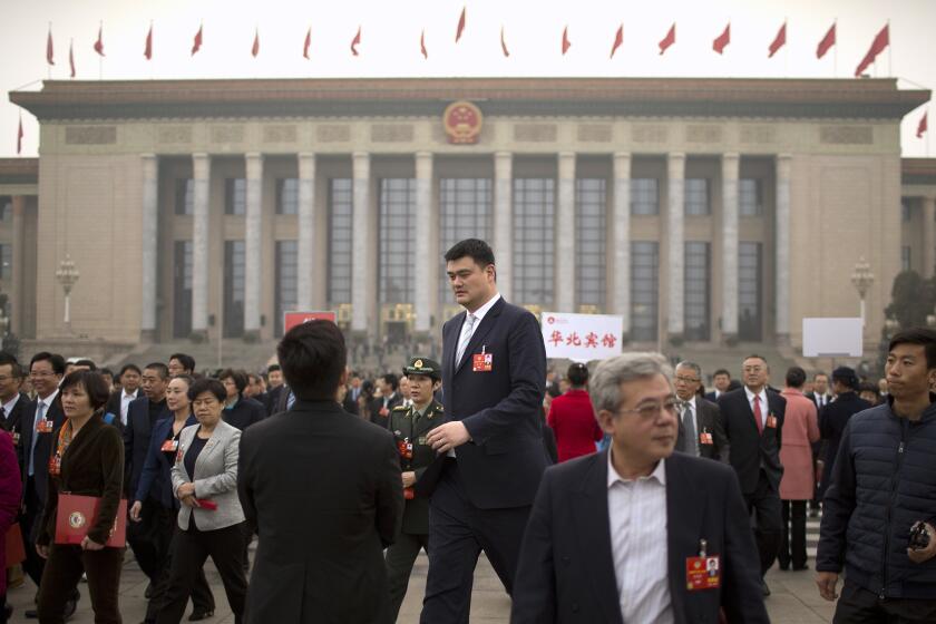 FILE - In this March 14, 2018, file photo, former NBA basketball player Yao Ming, center, a delegate to the Chinese People's Political Consultative Conference (CPPCC), leaves after a plenary session of the CPPCC at the Great Hall of the People in Beijing. Yao is now president of the Chinese Basketball Association, which announced over the weekend it is suspending its ties with the Rockets in retaliation for Houston Rockets general manager Daryl Morey's tweet that showed support for Hong Kong anti-government protesters. (AP Photo/Mark Schiefelbein, File)