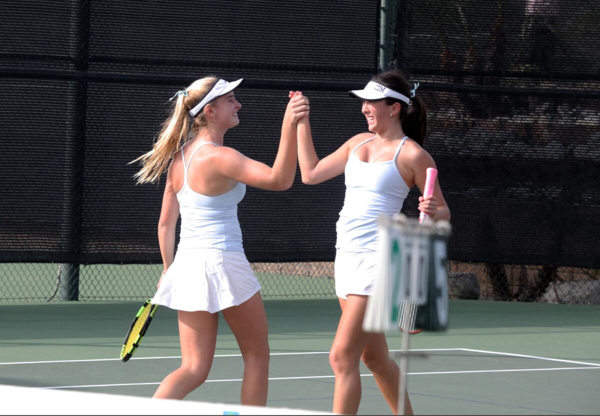Corona del Mar's Alden Mulroy, left, and Tori Varela high-five after winning their doubles set against Marlborough in the CIF Southern Section Division 1 title match at the Claremont Club on Friday.