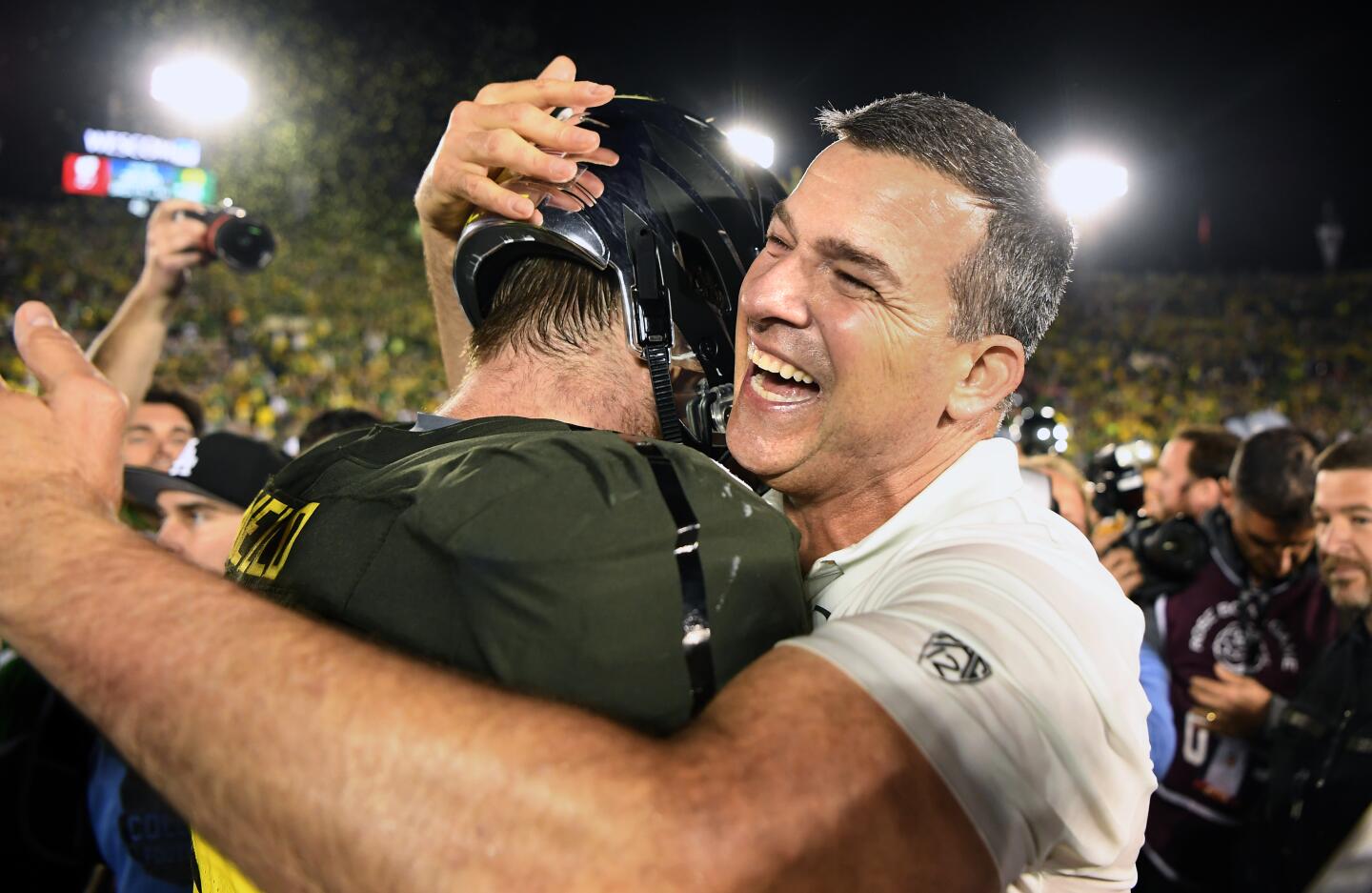 Oregon coach Mario Cristobal hugs a player after the Ducks' win over Wisconsin in the Rose Bowl.