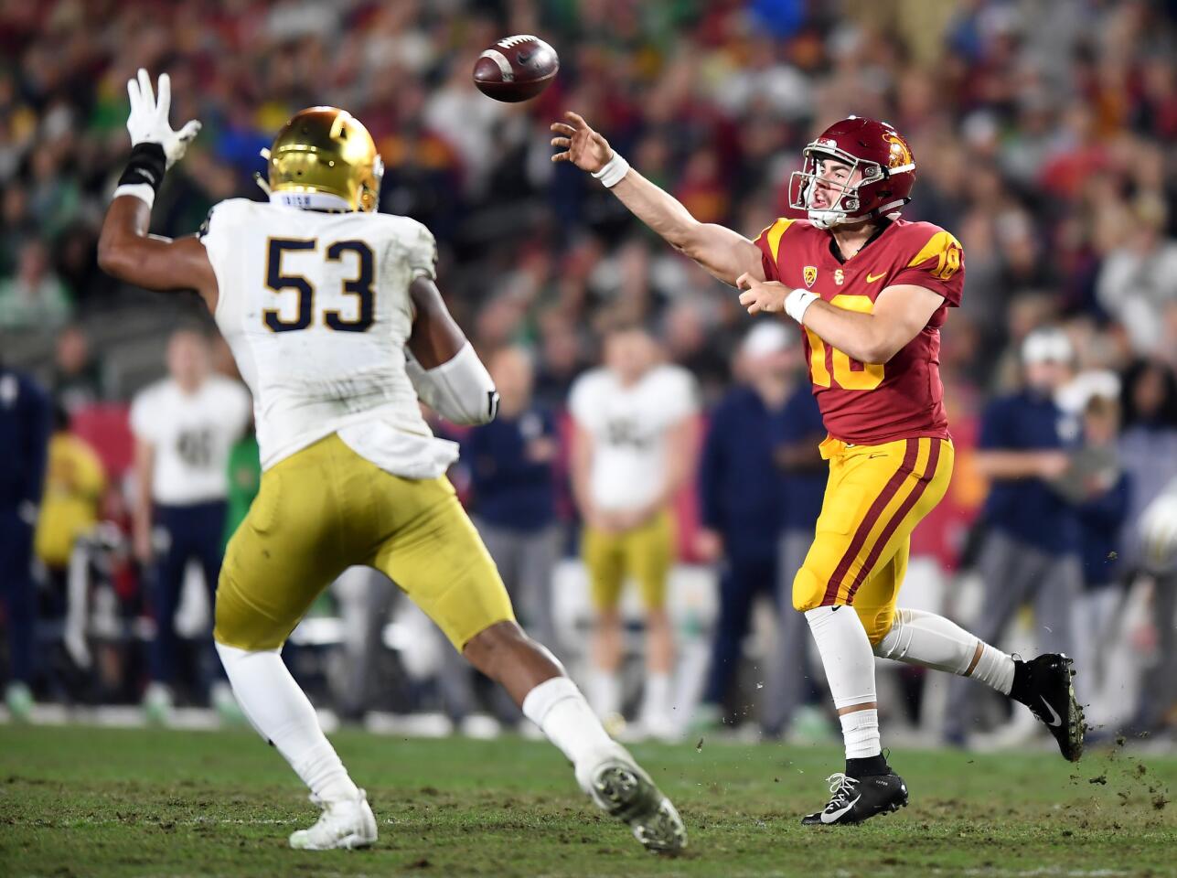USC quarterback J.T. Daniels gets a pass off in front of Notre Dame's Kahlid Kareem at the Coliseum.