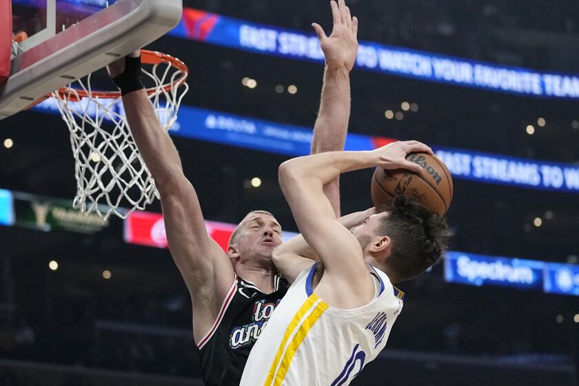Golden State Warriors guard Ty Jerome, right, shoots as Los Angeles Clippers center Mason Plumlee defends during the first half of an NBA basketball game Tuesday, Feb. 14, 2023, in Los Angeles. (AP Photo/Mark J. Terrill)