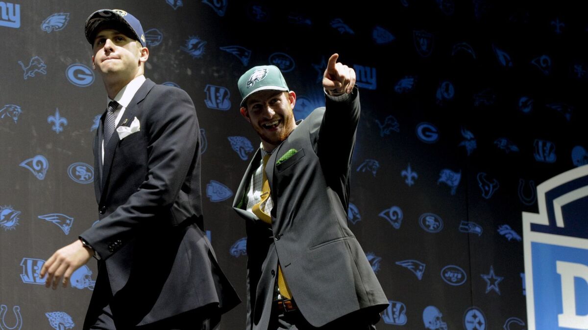 Jared Goff, left, after being selected by the Rams as their No. 1 overall pick, and Carson Wentz, after being selected by the Philadelphia Eagles as their top pick and No. 2 in the first round, at the 2016 NFL football draft in Chicago.
