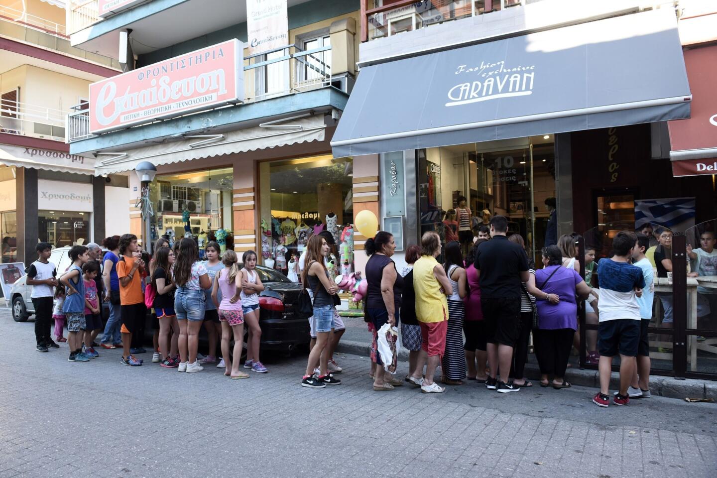 Greeks line up for free sandwiches at a shop in the northern port city of Thessaloniki on July 2, offered as citizens struggle with closed banks and severe limits on their access to cash.