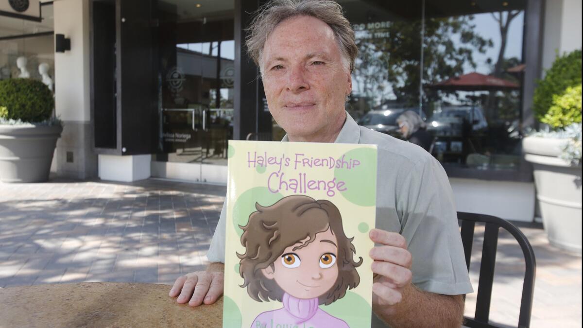 Newport Beach children’s book author Louie Lawent shows his latest effort, “Haley’s Friendship Challenge,” which is available on Amazon.