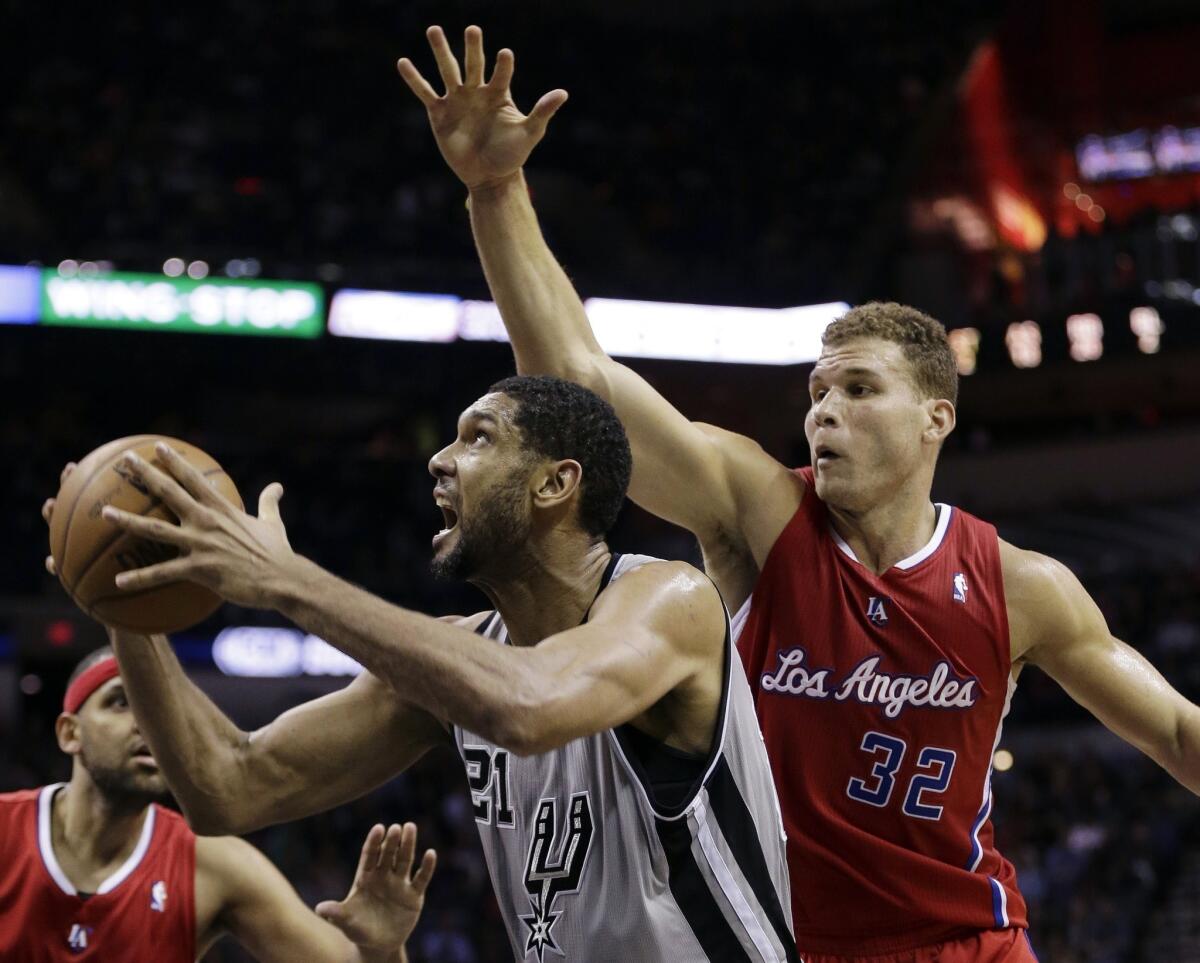Spurs power forward Tim Duncan tries to power his way to the basket against Clippers power forward Blake Griffin during a game last month in San Antonio.