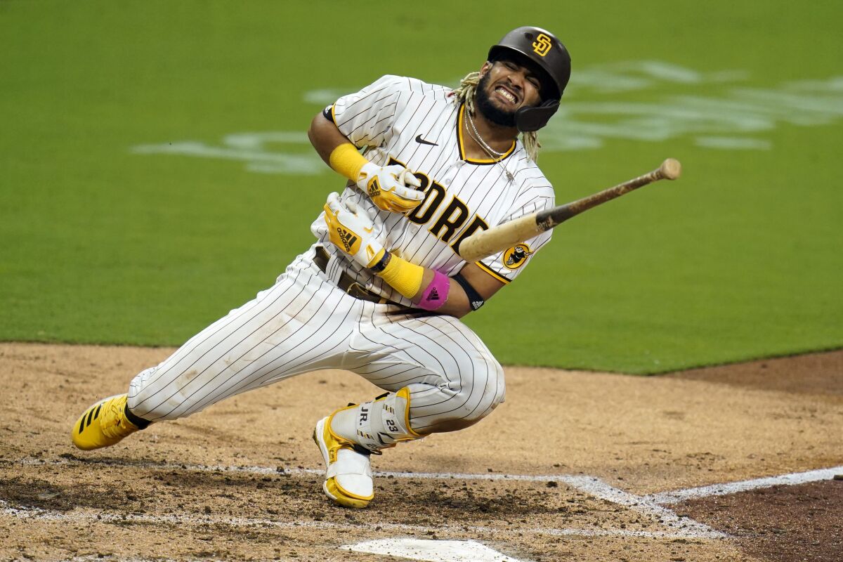 San Diego Padres' Fernando Tatis Jr. reacts after being hit by a pitch while batting during the seventh inning of a baseball game against the Colorado Rockies, Monday, Sept. 7, 2020, in San Diego. (AP Photo/Gregory Bull)