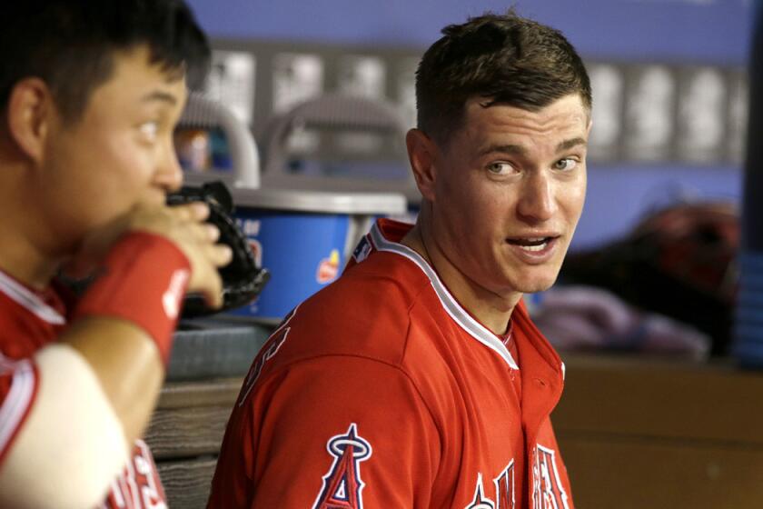 Angels starting pitcher Garrett Richards, right, talks with catcher Hank Conger during the seventh inning of their game against the Rangers on Friday night in Arlington, Texas.