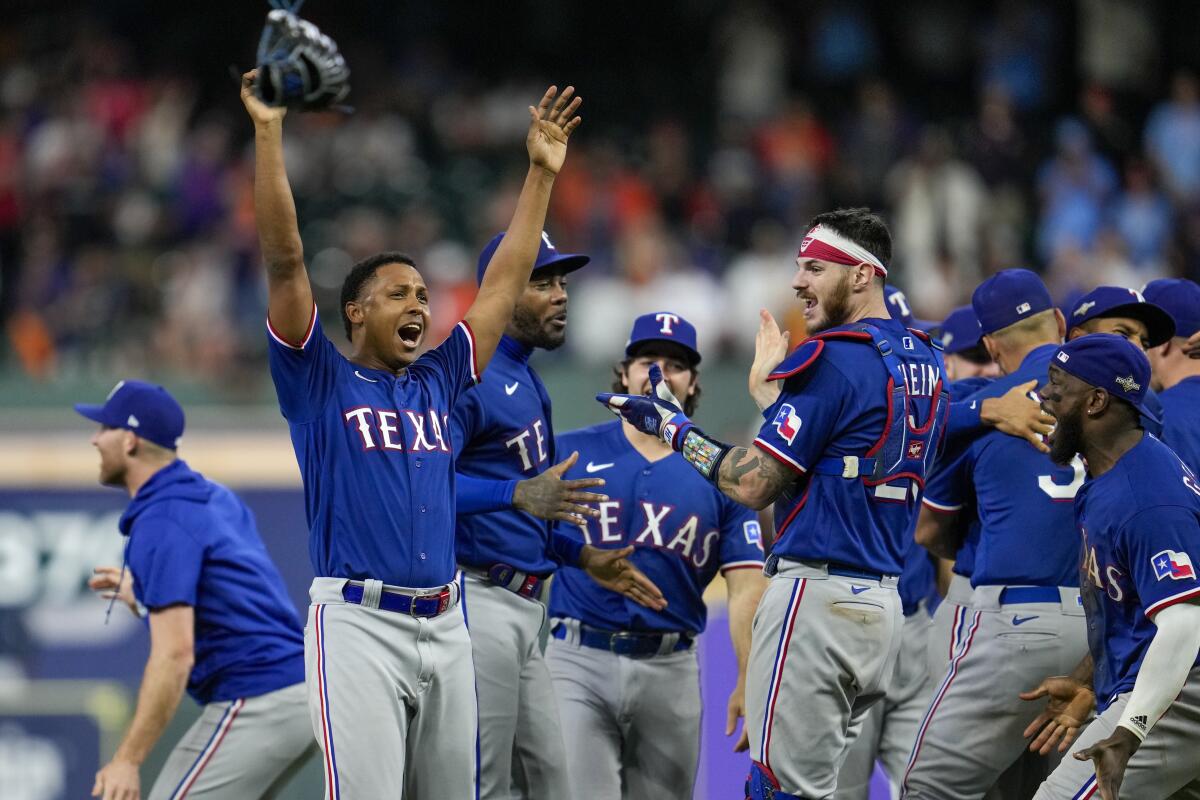 The Texas Rangers celebrate after defeating the Houston Astros in Game 7 of the American League Championship Series.