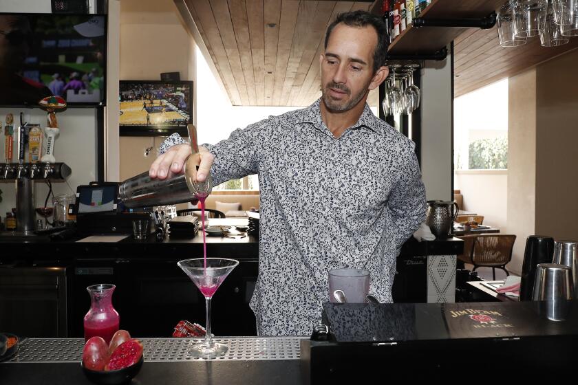Lead bartender John Abreu pours a desert rose at Little Onion Mexican Restaurant in Irvine.