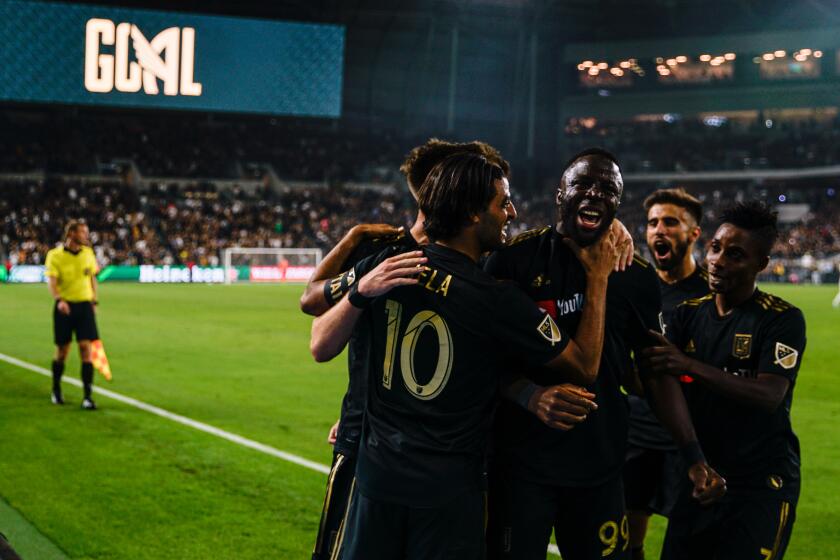 LOS ANGELES, CALIF. - OCTOBER 24: Los Angeles FC forward Adama Diomande (99) and teammates celebrate his goal during a match between the Los Angeles FC and the Los Angeles Galaxy at Banc of California Stadium, on Thursday, Oct. 24, 2019 in Los Angeles, Calif. Los Angeles FC defeated the Los Angeles Galaxy 5-3. (Kent Nishimura / Los Angeles Times)
