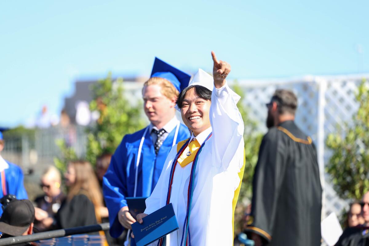 Fountain Valley graduates wearing white caps and gowns earned the title of summa cum laude.