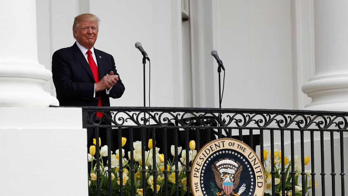 President Donald Trump arrives on the Truman Balcony for the annual White House Easter Egg Roll on the South Lawn of the White House. Analysts say his policy's are moving investors bank into the bond market.