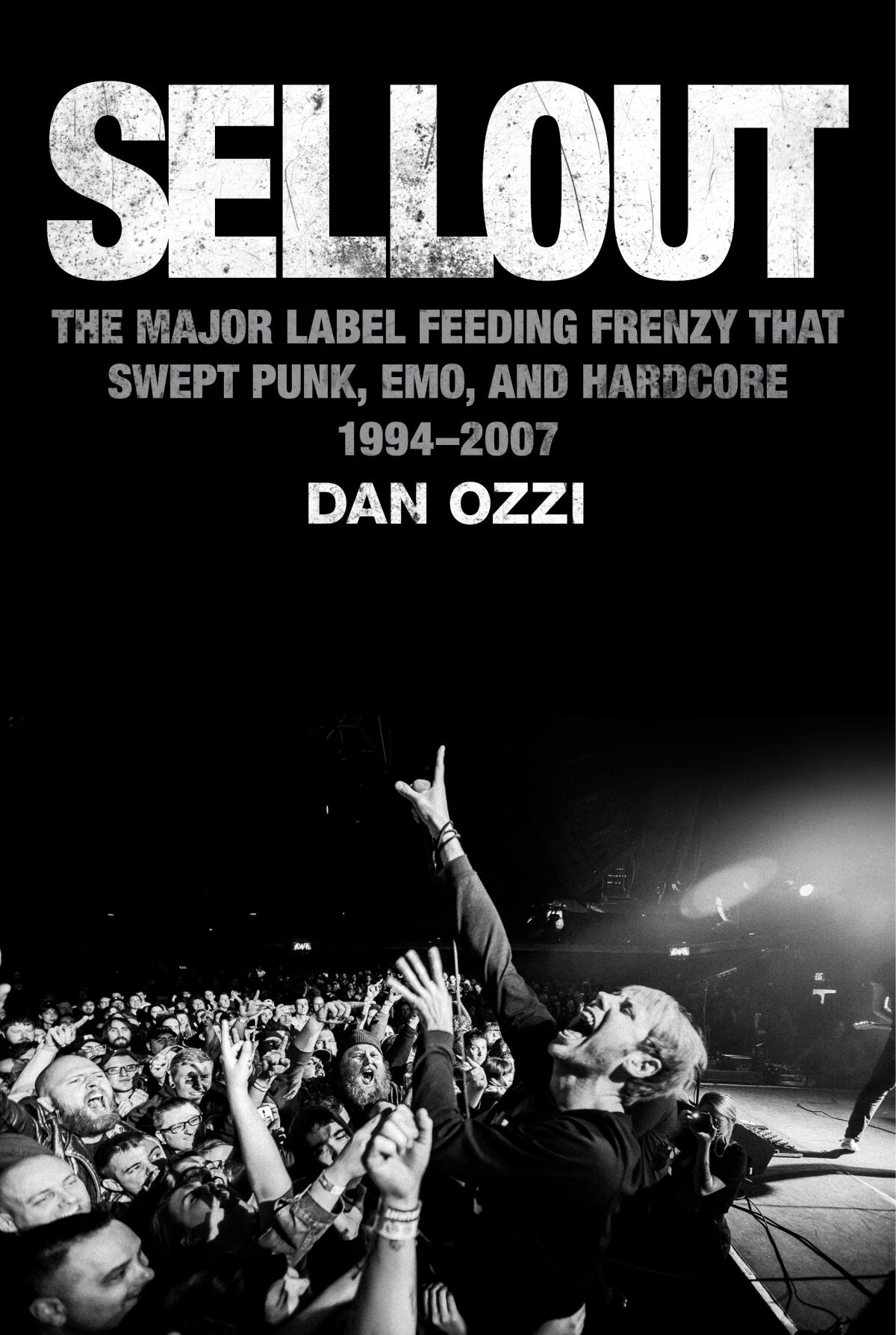 A singer performs in front of a rowdy crowd on the cover of the book "Sellout."