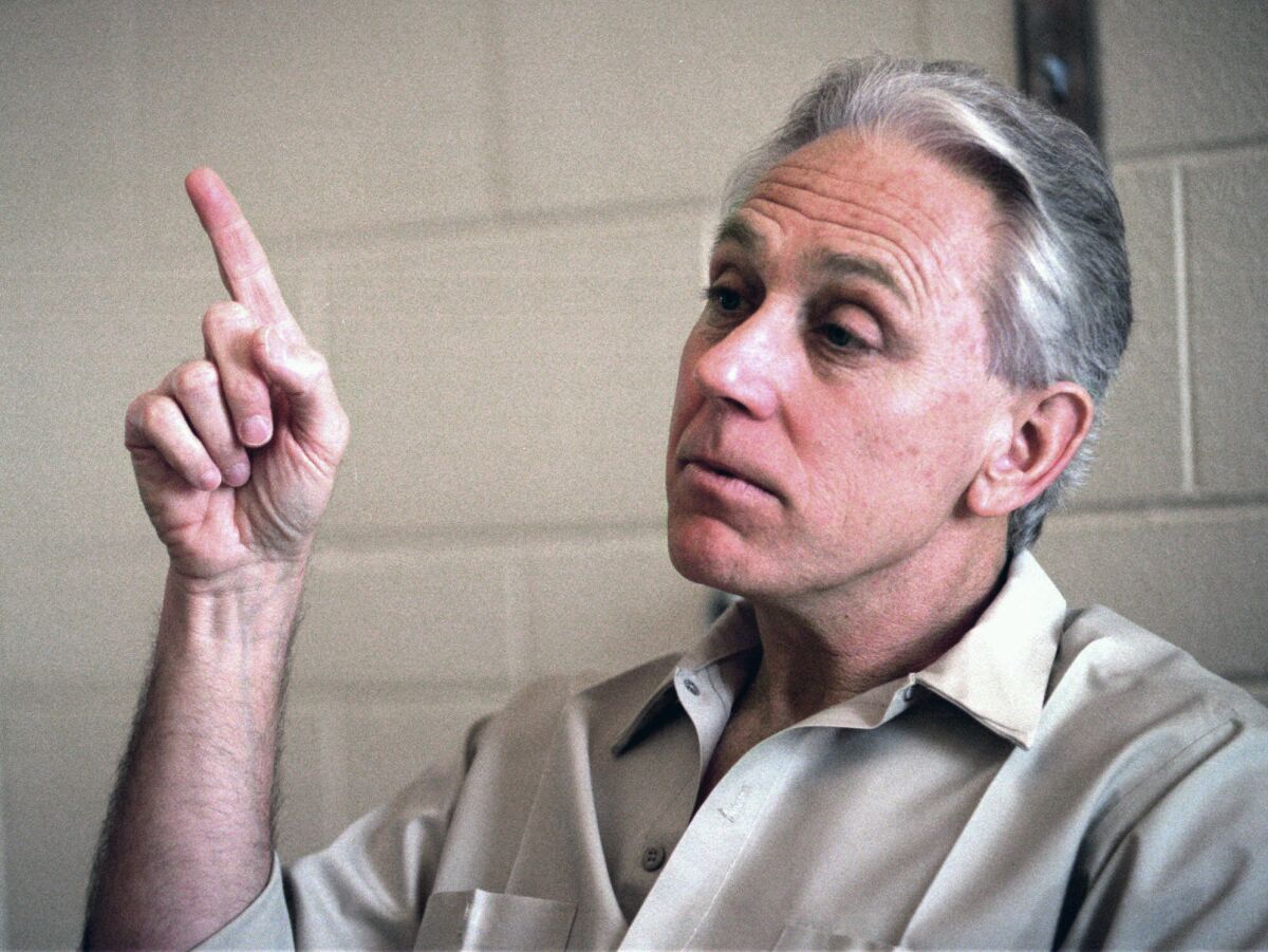 FILE - In this March 1, 1995, file photo Jeffrey MacDonald gestures at the federal correctional institution in Sheridan, Ore. MacDonald a former Army doctor convicted for the 1970 slayings of his wife and two young daughters at North Carolina's Fort Bragg has ended his appeal of a court ruling denying his requested release. The 4th U.S. Circuit Court of Appeals granted MacDonald's appeal dismissal on Thursday, Sept. 16, 2021. He is serving a life sentence in a Maryland prison. (AP Photo/Shane Young, File)