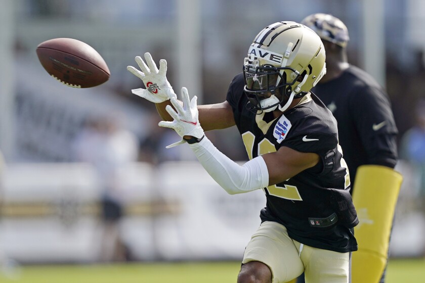 Chris Olave catches passes during Saints training camp 