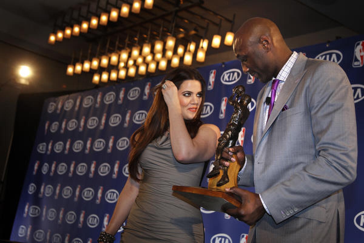 Khloe Kardashian watches her husband, Lamar Odom, then a forward for the Los Angeles Lakers, who received the Sixth Man Award in 2011.