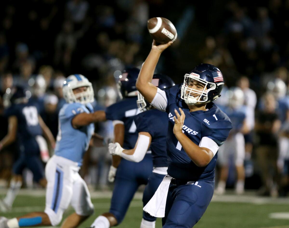 Newport Harbor quarterback Nick Kim throws a long pass in the Battle of the Bay game against Corona del Mar on Friday at Davidson Field.