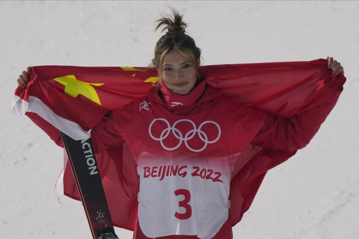 Silver medal winner China's Eileen Gu celebrates during the venue award ceremony for the women's slopestyle finals at the 2022 Winter Olympics, Tuesday, Feb. 15, 2022, in Zhangjiakou, China. (AP Photo/Francisco Seco)