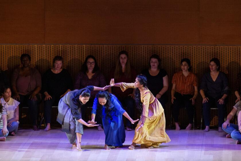 LOS ANGELES, CA-APRIL 18, 2019: Cambodian dancers Nam Narin, Sam Sathya and Chumvan Sodhachivy, left to right, perform during Perséphone, as Esa-Pekka Salonen conducts at the Walt Disney Concert Hall on on April 18, 2019, in Los Angeles, California. (Photo By Dania Maxwell / Los Angeles Times)