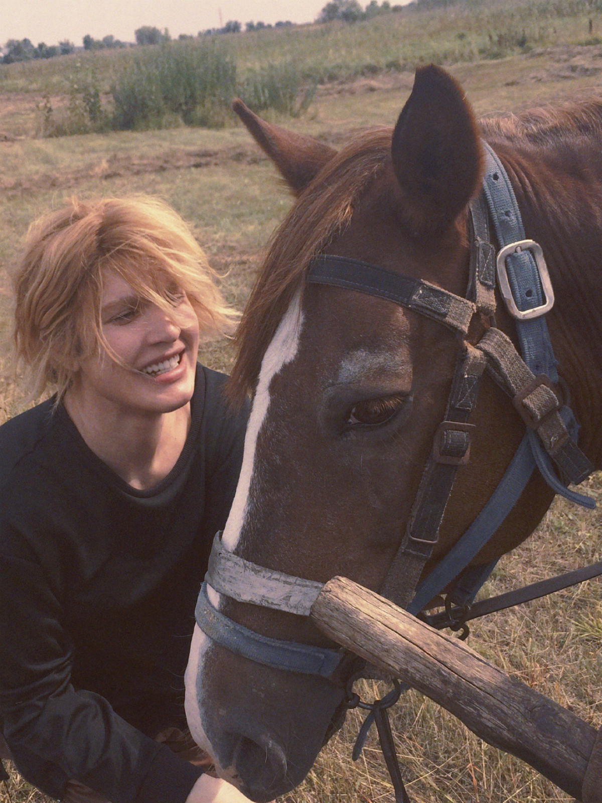 A woman pets a horse