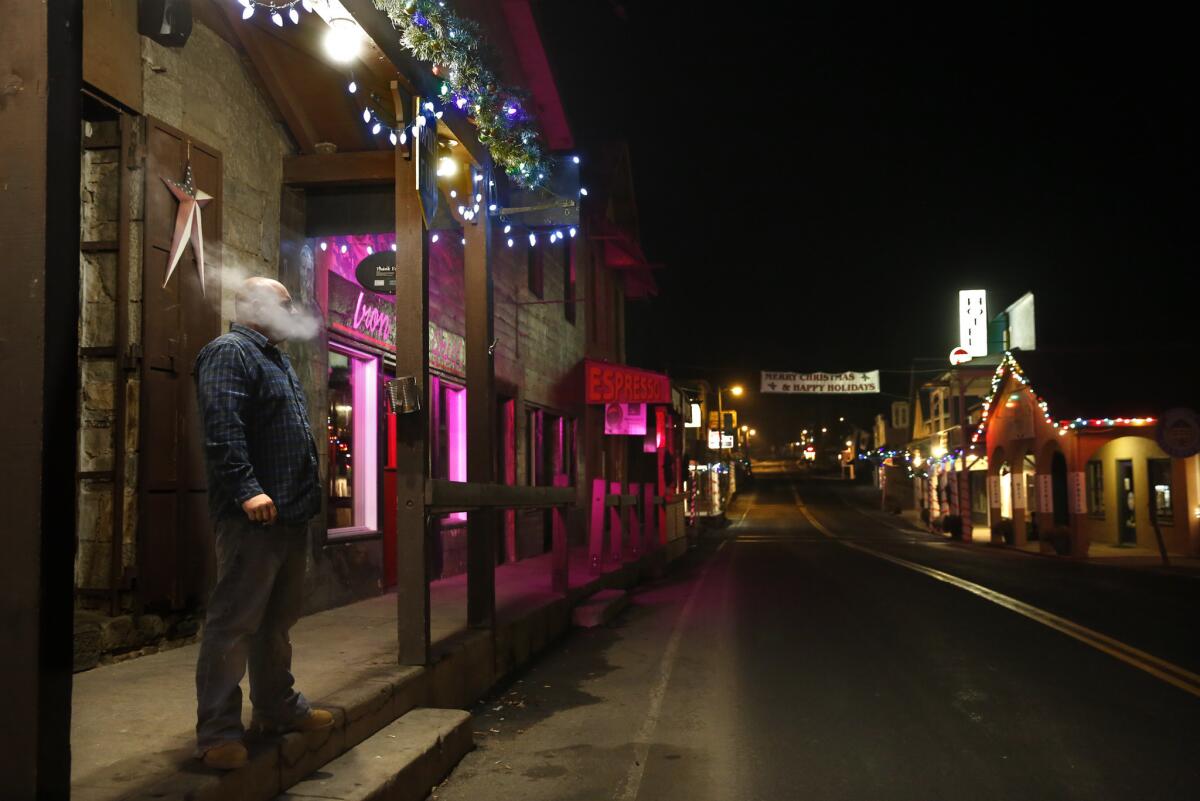 On a chilly December night a patron takes a smoke break outside the 118-year-old Iron Door Saloon in Groveland.