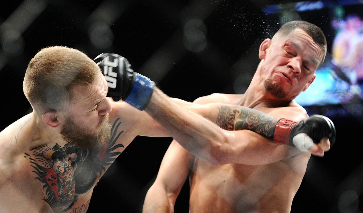 Conor McGregor, left, and Nate Diaz exchange punches during their welterweight fight at UFC 196 on March 5.