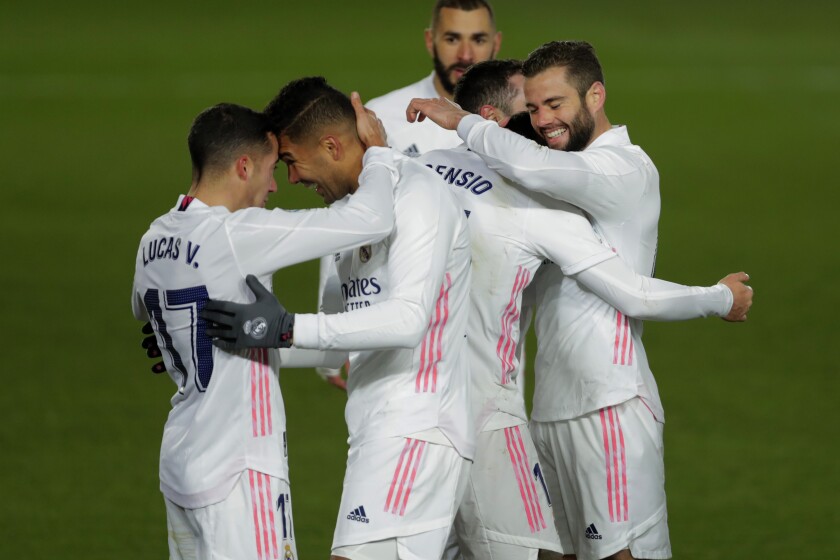 Real Madrid's Marco Asensio celebrates with teammates after scoring.