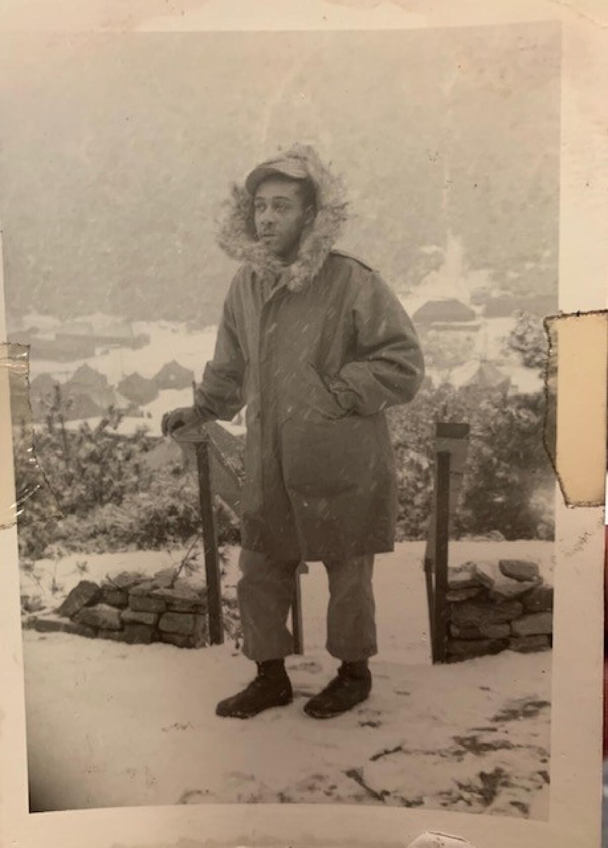A photograph from 1951 or 1952 taken of Marine Robert L. Moore near a winter battle camp during the Korean War. 