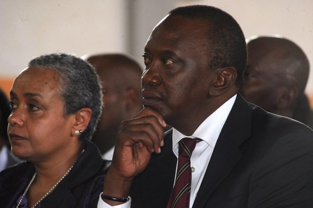 Kenya's president-elect, Uhuru Kenyatta, and his wife, Margaret Kenyatta, attend a mass at the Martyrs of Uganda Catholic church Sunday in Gatundu, Kenya. The election results are being disputed but calm has prevailed, in striking contrast to the aftermath of balloting in 2007.