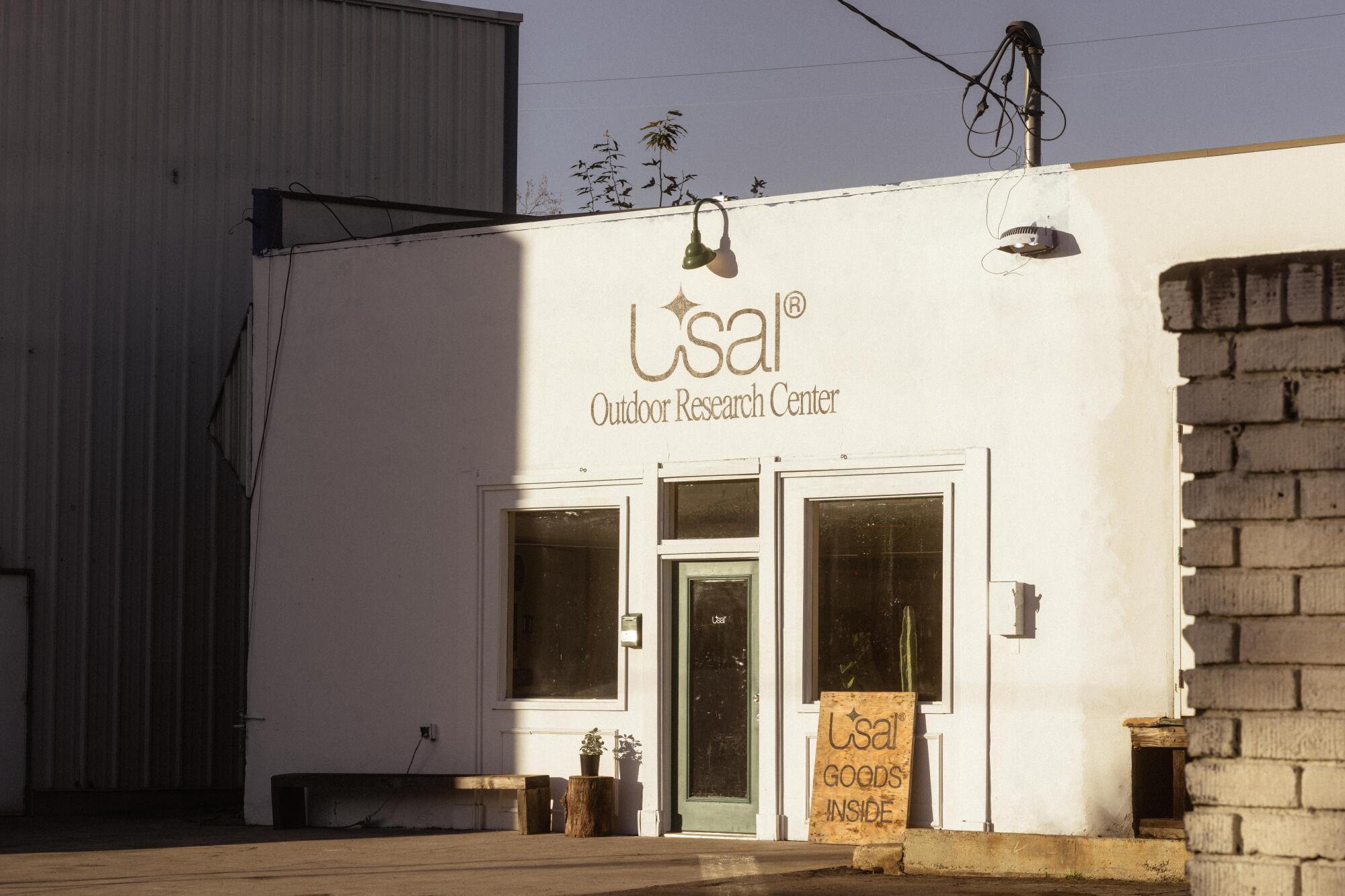 A white storefront with the words Usal Outdoor Research Center above its door