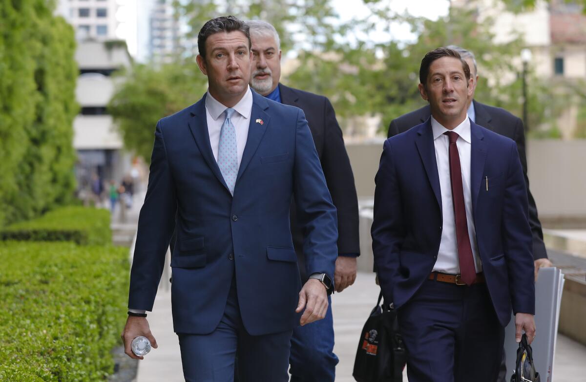 Duncan Hunter in a suit and tie walks to court with his legal team