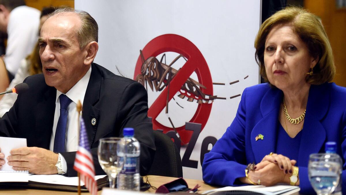 Marcelo Casto, Brazil's minister of health, and Liliana Ayalde, the U.S. ambassador to Brazil, take part in a conference discussing the Zika virus and the upcoming Olympics on Thursday in Brasilia.