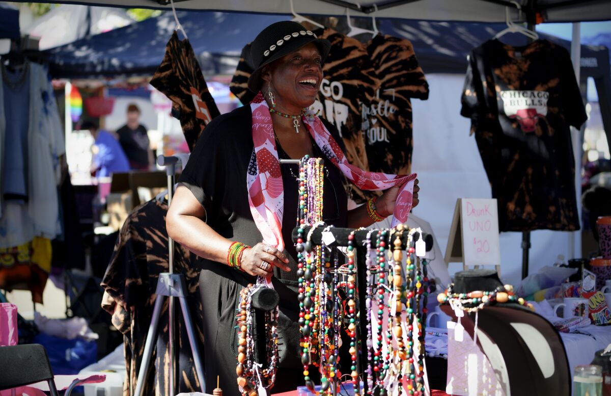 Shoshanna Cordes stands in front of colorful beads and dances.