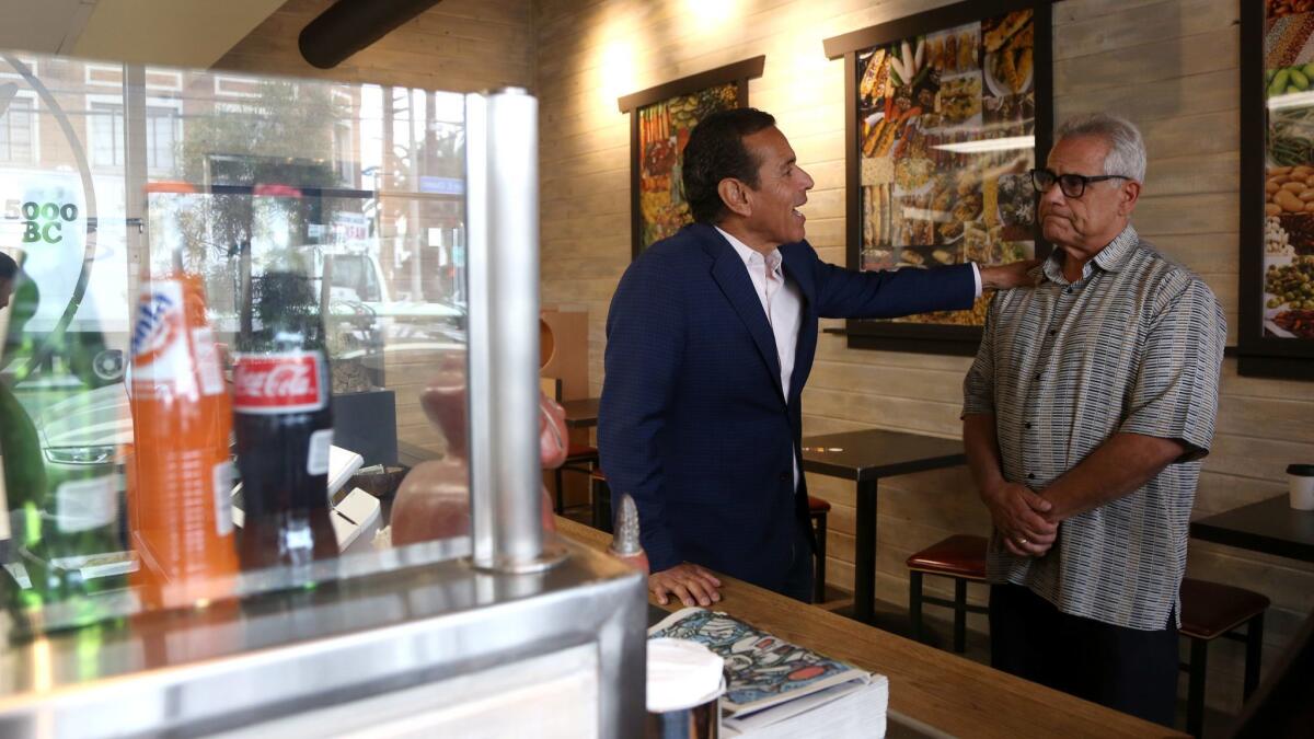 Antonio Villaraigosa talks with Milpa Grille owner Dan Morales on Saturday.