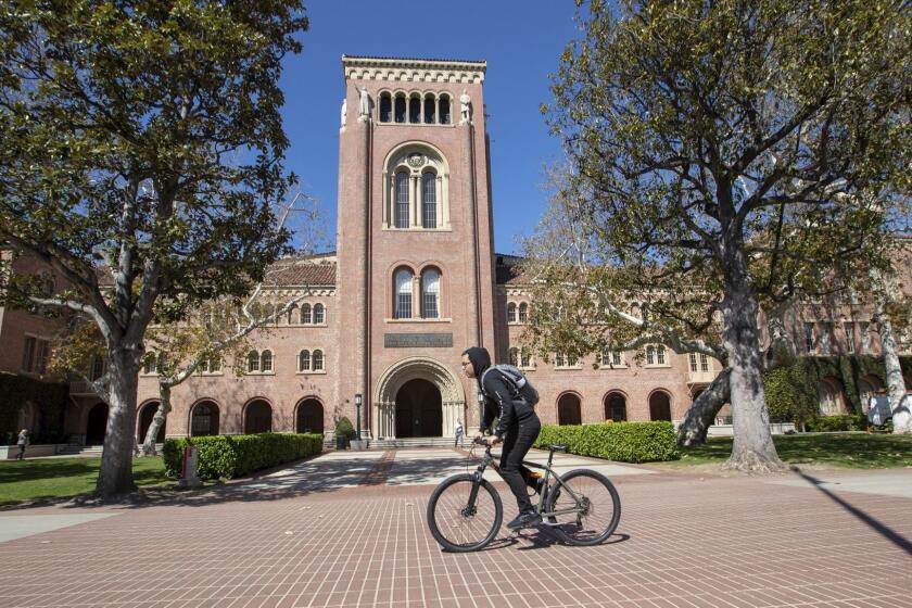 LOS ANGELES, CALIF. -- TUESDAY, MARCH 12, 2019: A view of people visiting the University of Southern California in Los Angeles, Calif., on March 12, 2019. Federal prosecutors say their investigation dubbed Operation Varsity Blues blows the lid off an audacious college admissions fraud scheme aimed at getting the children of the rich and powerful into elite universities. According to prosecutors, wealthy parents paid a firm to help their children cheat on college entrance exams and falsify athletic records of students to enable them to secure admission to schools such as UCLA, USC, Stanford, Yale and Georgetown. Two USC athletic department employees  a high-ranking administrator and a legendary head coach  were fired Tuesday after being indicted in federal court in Massachusetts for their alleged roles in a racketeering conspiracy that helped students get into elite colleges and universities by falsely designating them as recruited athletes. (Allen J. Schaben / Los Angeles Times)