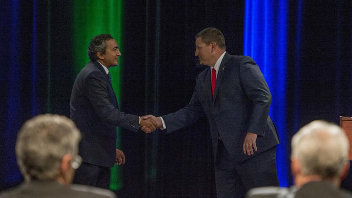 Democratic U.S. Rep. Ami Bera, left, shakes hands with his Republican challenger, Sacramento County Sheriff Scott Jones, after their debate in the race for the 7th Congressional District seat.