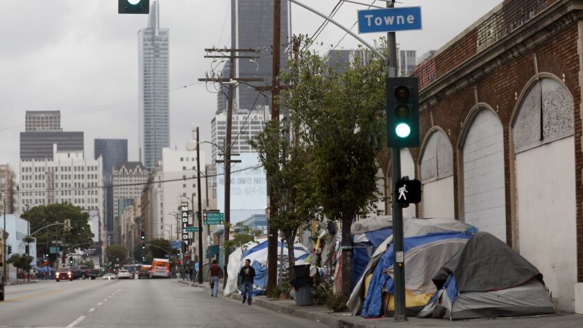 Tents line a sidewalk in downtown Los Angeles earlier this year. Los Angeles County's annual homeless report concluded that there were more tents and vehicles being used as shelter than in the year before, but that fewer people were inhabiting them.
