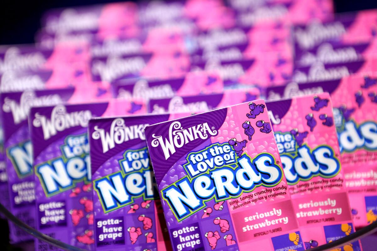 A close-up frame of rows of pink-and-purple boxes of candy