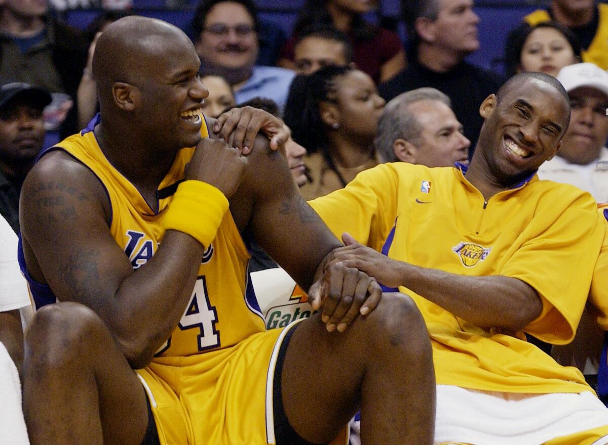 Lakers Shaquille O'Neal and Kobe Bryant share a laugh on the bench during the 2003 season